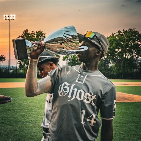 Ghost South player kissing the championship trophy at sunset