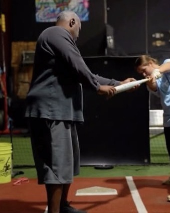 Roger Lewis giving a hitting lesson